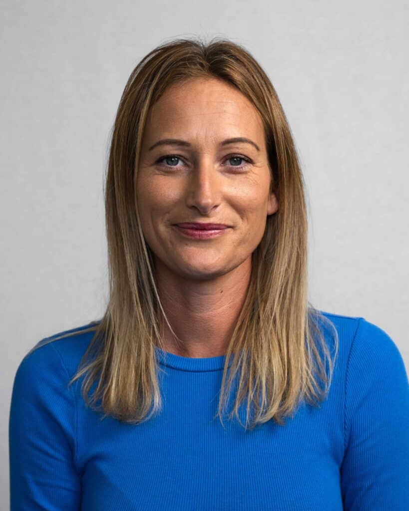 Female client manager headshot in a blue top